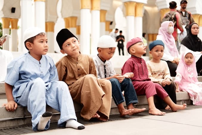 Young students sitting attentively in traditional classroom attire learning Arabic
